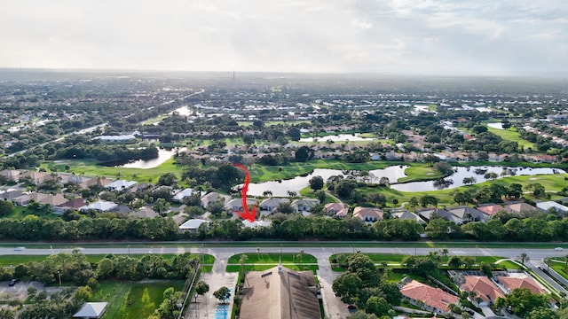 bird's eye view with a residential view, view of golf course, and a water view