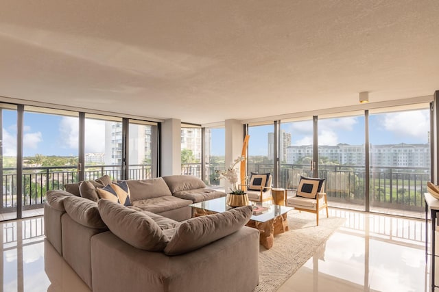 living room with expansive windows, a view of city, and a textured ceiling