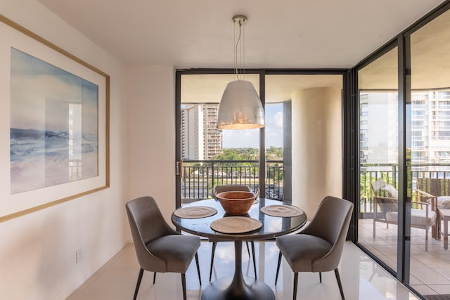 tiled dining room with a wall of windows