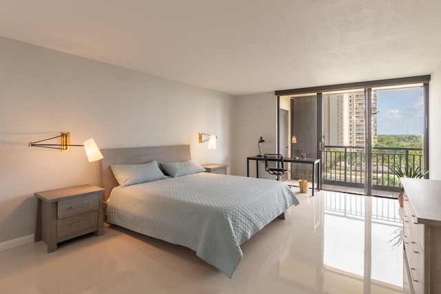 bedroom with access to exterior and floor to ceiling windows