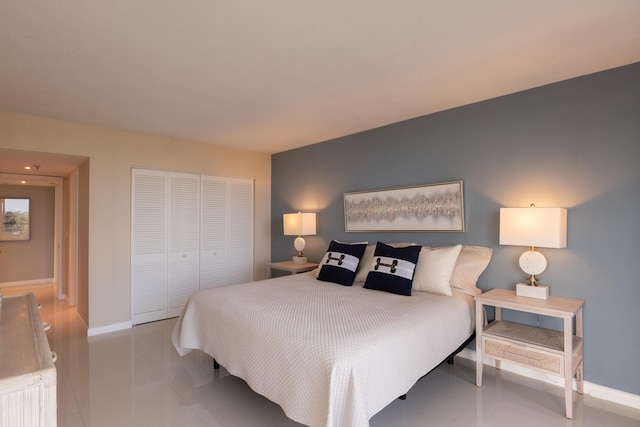 bedroom featuring light tile patterned floors and a closet