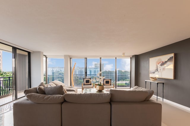 tiled living room featuring a wall of windows and a healthy amount of sunlight