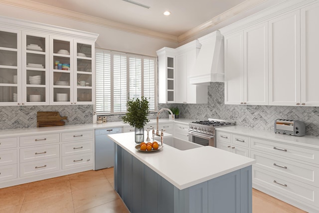 kitchen featuring dishwasher, an island with sink, decorative backsplash, high end range, and custom range hood