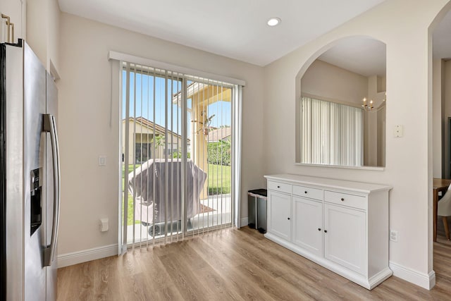 interior space featuring a notable chandelier and light hardwood / wood-style flooring