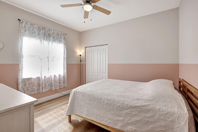 bedroom featuring a closet, light hardwood / wood-style floors, and ceiling fan