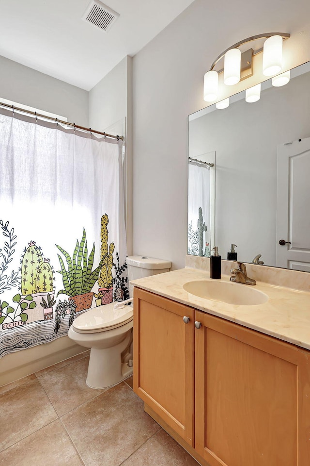 bathroom with tile patterned floors, vanity, and toilet