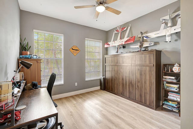 home office with ceiling fan, light hardwood / wood-style flooring, and a healthy amount of sunlight