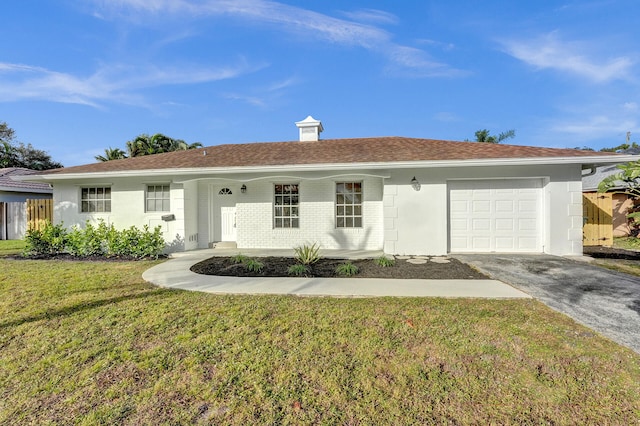 ranch-style house with a garage and a front yard