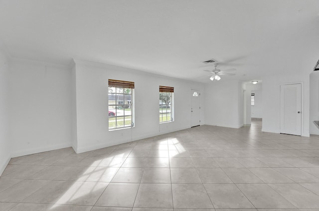 tiled empty room with ornamental molding and ceiling fan