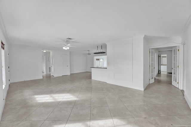 unfurnished room with french doors, light tile patterned floors, crown molding, and ceiling fan