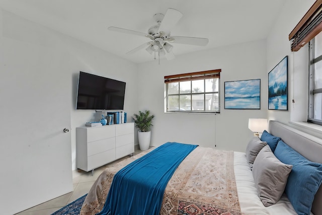 tiled bedroom featuring ceiling fan