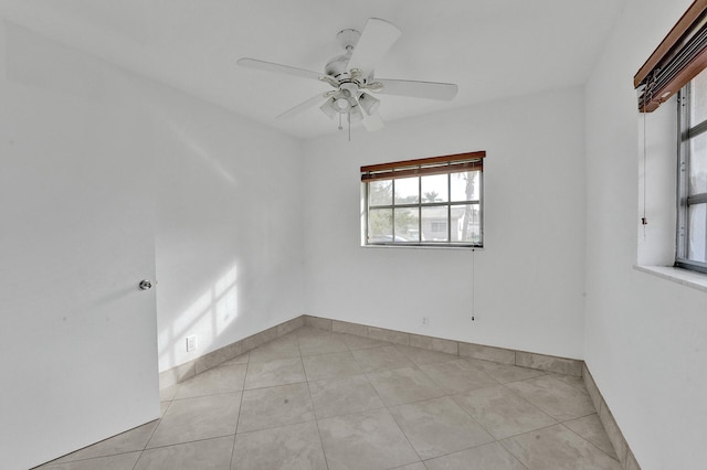 spare room with light tile patterned floors and ceiling fan