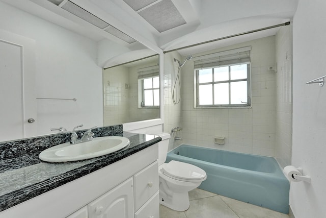 full bathroom with toilet, vanity, tiled shower / bath combo, and tile patterned floors