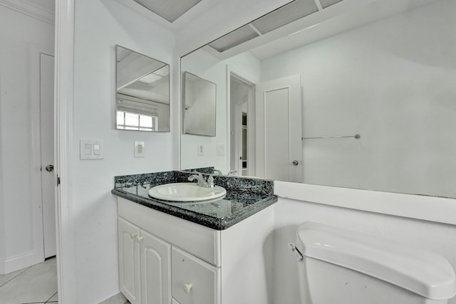 bathroom featuring vanity, tile patterned floors, and toilet