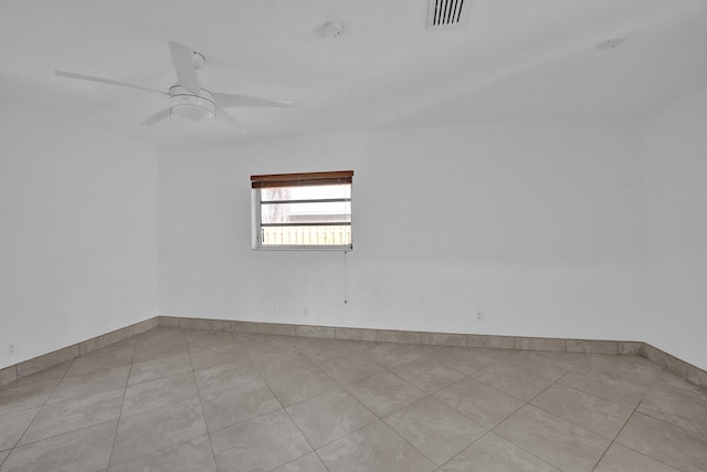 unfurnished room featuring ceiling fan and light tile patterned floors