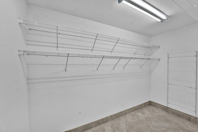 spacious closet featuring light tile patterned floors