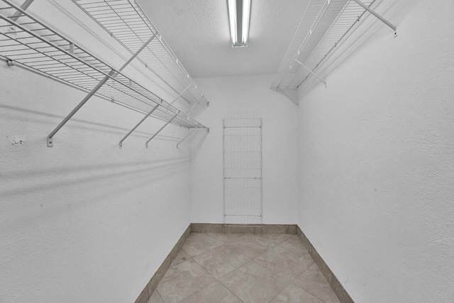 spacious closet with tile patterned flooring