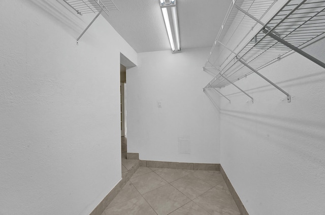 spacious closet with tile patterned floors