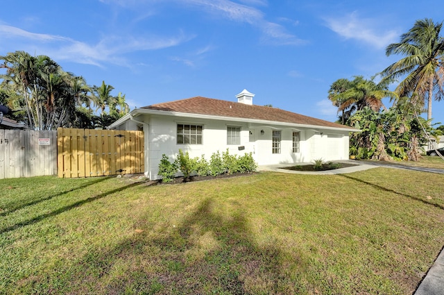 ranch-style house with a front lawn