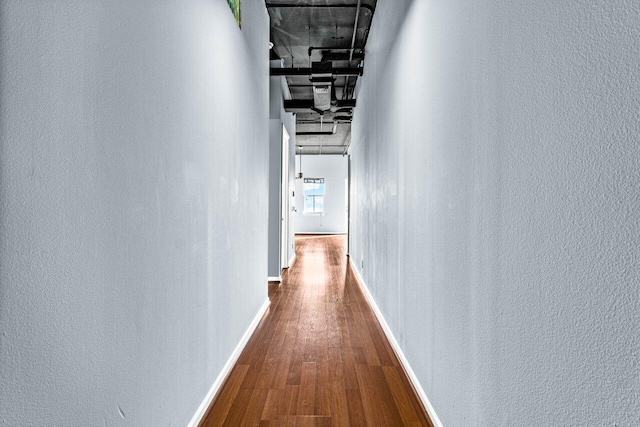 corridor with wood-type flooring