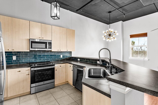 kitchen featuring appliances with stainless steel finishes, light brown cabinets, pendant lighting, sink, and kitchen peninsula