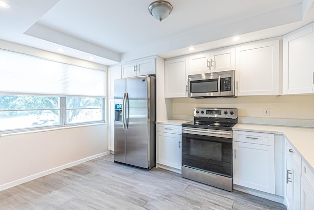 kitchen with white cabinetry and appliances with stainless steel finishes