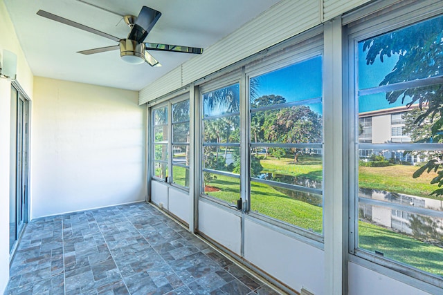 unfurnished sunroom featuring ceiling fan