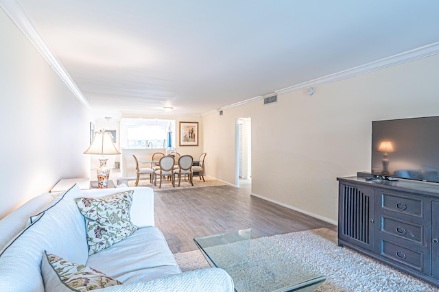 living room featuring crown molding and wood-type flooring