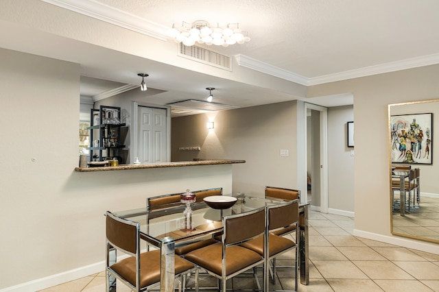 dining room featuring light tile patterned floors and crown molding