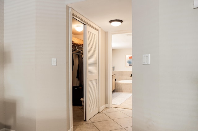 hall featuring light tile patterned floors