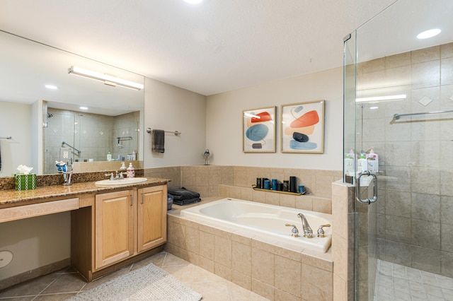 bathroom with vanity, independent shower and bath, and tile patterned floors