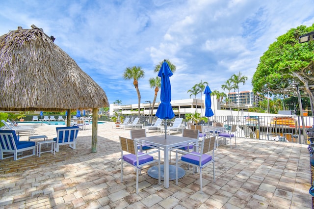 view of patio with a water view and a gazebo