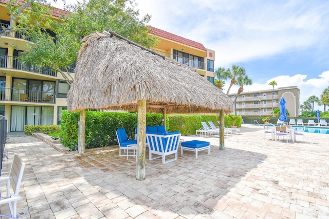 view of patio / terrace with a balcony and a community pool