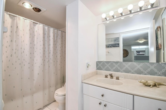 bathroom featuring toilet, a shower with curtain, vanity, and tile patterned floors