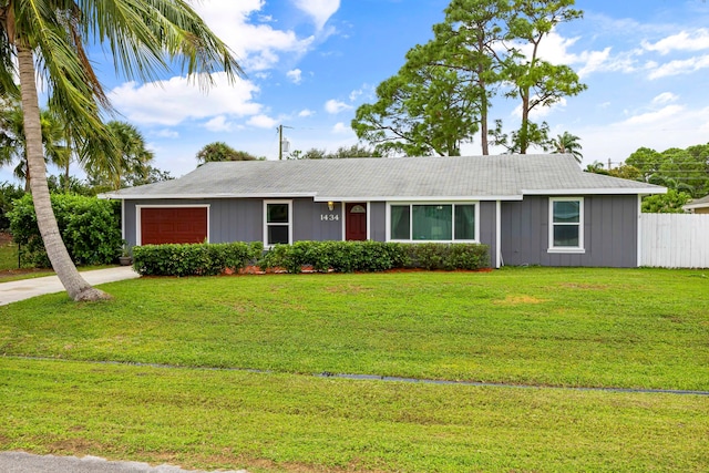 single story home with a garage and a front yard