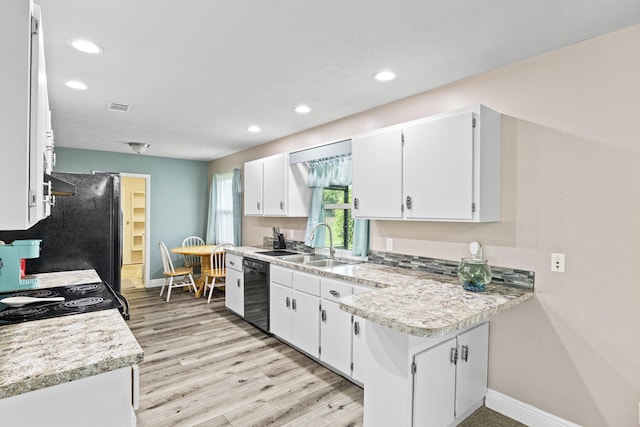 kitchen with white cabinetry, sink, light hardwood / wood-style flooring, and black dishwasher