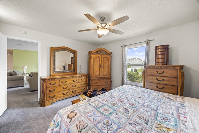 carpeted bedroom featuring a textured ceiling and ceiling fan