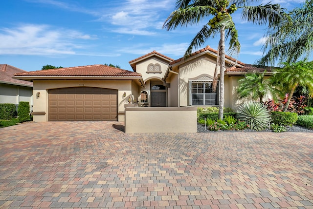 mediterranean / spanish home featuring a garage