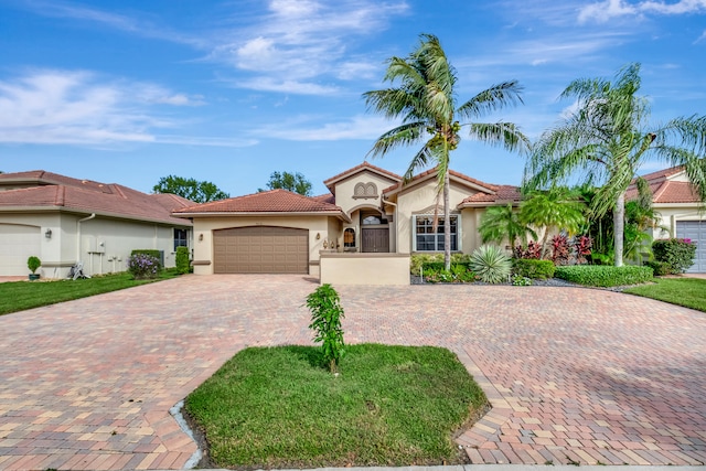 mediterranean / spanish-style home with a garage