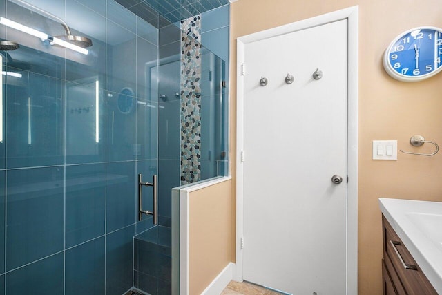 bathroom featuring walk in shower and vanity