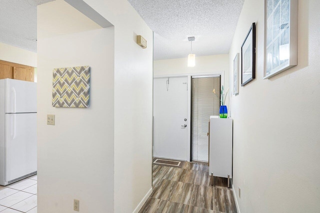 corridor featuring hardwood / wood-style floors and a textured ceiling