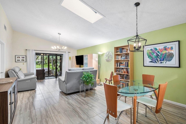 dining room featuring lofted ceiling, a textured ceiling, and a notable chandelier