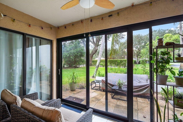 doorway to outside featuring ceiling fan and lofted ceiling