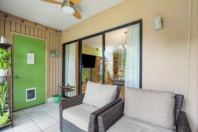 sunroom / solarium featuring ceiling fan