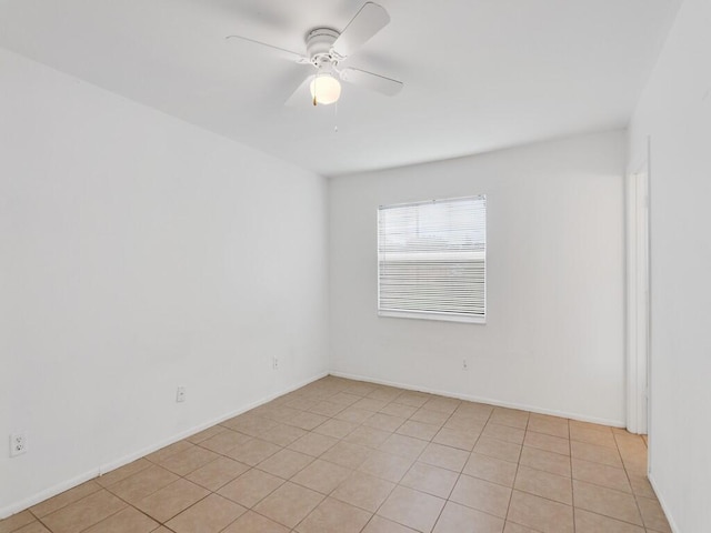 tiled spare room with ceiling fan