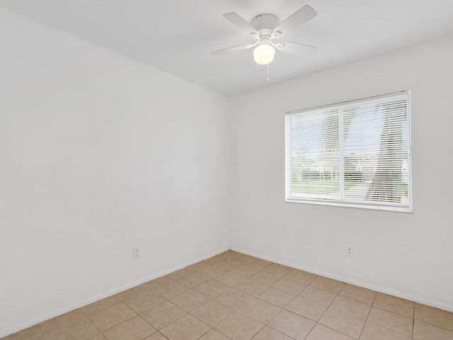 tiled empty room featuring ceiling fan