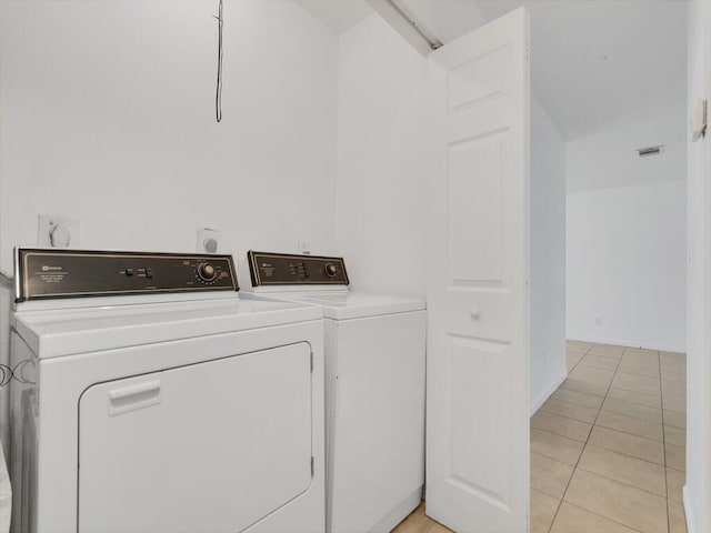 washroom featuring light tile patterned flooring and independent washer and dryer