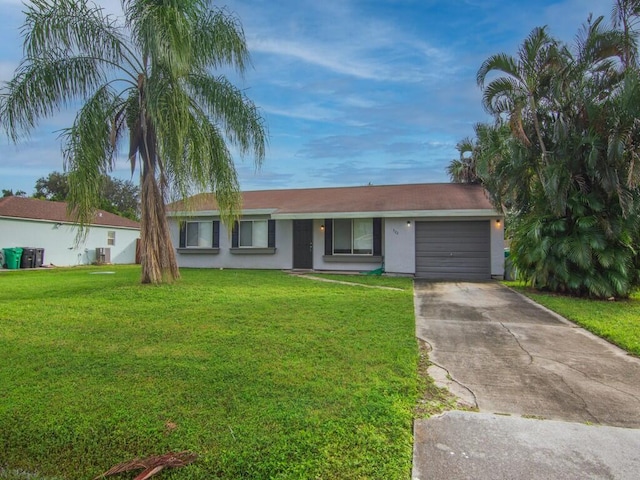 ranch-style house with driveway, a garage, stucco siding, and a front lawn