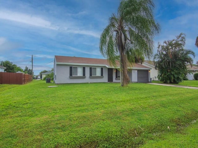 single story home featuring a garage and a front yard