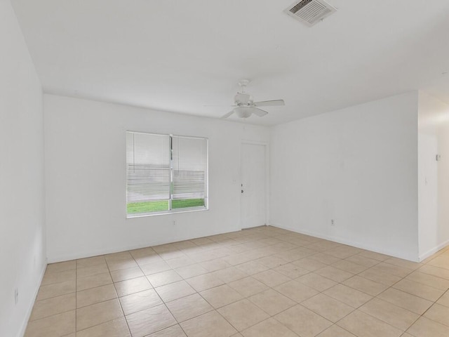 tiled empty room with ceiling fan